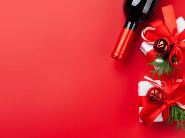 a red square with a wine bottle and gifts lining the right side